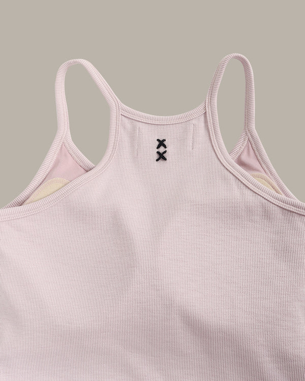 Pink ribbed tank top with thin straps on a gray background
