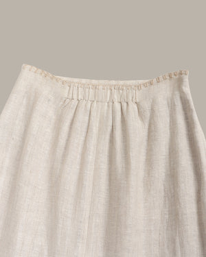 Beige linen skirt with a plain background