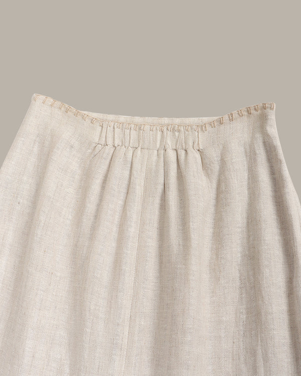 Beige linen skirt with a plain background