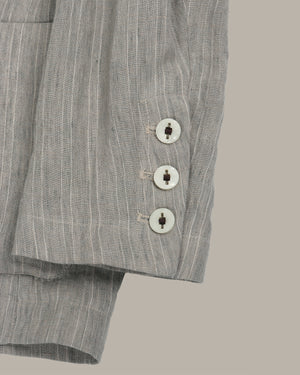 Gray striped pants with buttons on a beige background
