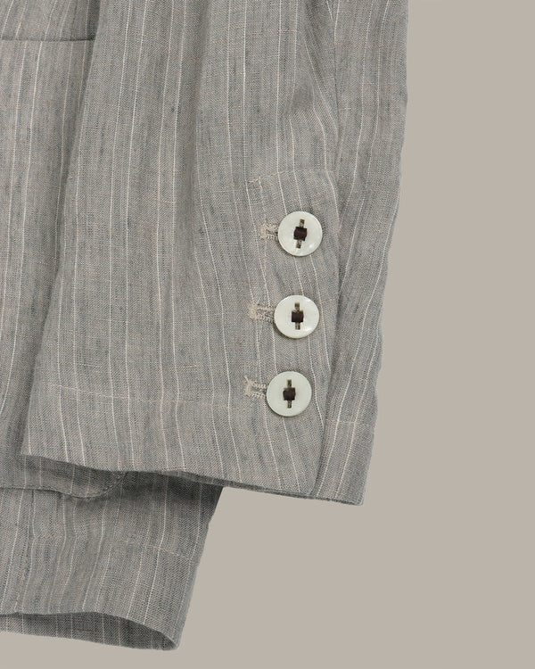 Gray striped pants with buttons on a beige background