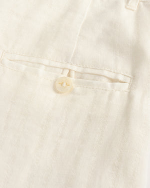 Close-up of a button on a light-colored fabric garment