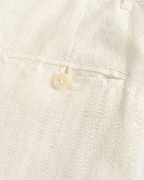 Close-up of a button on a light-colored fabric garment