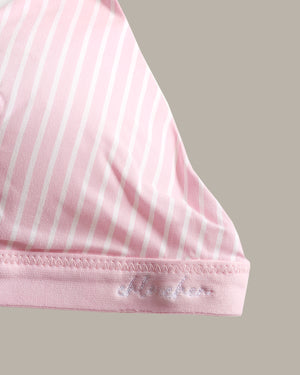 Close-up of a pink garment with thin white vertical stripes and a pink hemband featuring white embroidered script.
