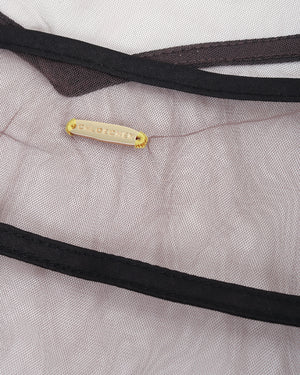 Close-up of a gray fabric with black trim and a yellow label.