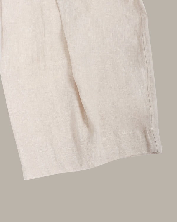 Close-up of a beige linen pants on a light gray background