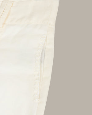 Close-up of a white shorts with a subtle texture on a light gray background