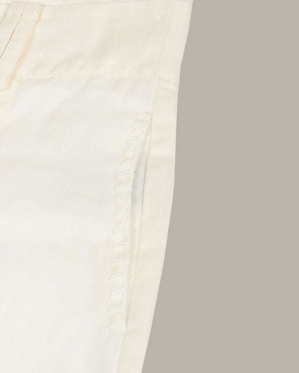 Close-up of a white shorts with a subtle texture on a light gray background