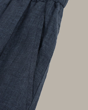 navy wide-leg pants on a light gray background