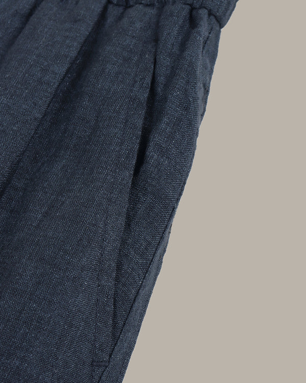 navy wide-leg pants on a light gray background