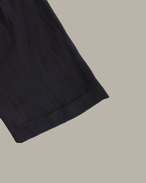 Close-up of a black fabric edge on a beige background