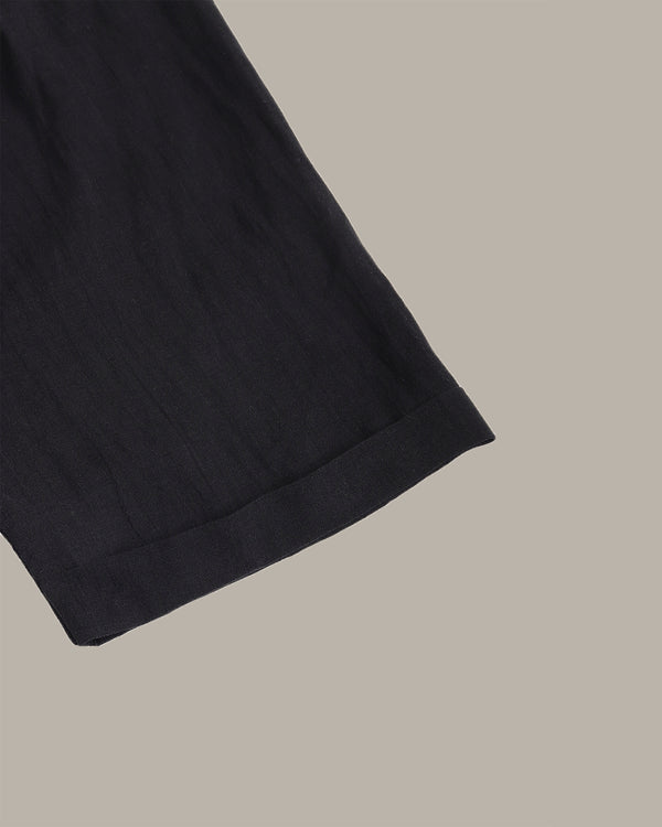 Close-up of a black fabric edge on a beige background