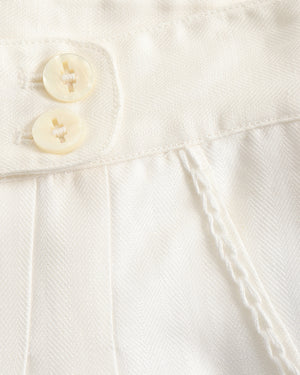 Close-up of a white textured fabric with buttons