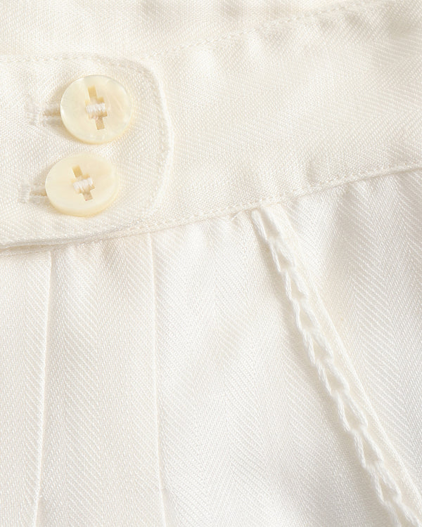 Close-up of a white textured fabric with buttons