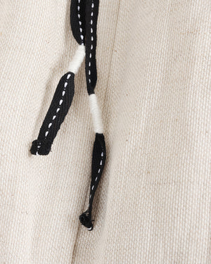 Black and white textured yarn on a beige fabric background