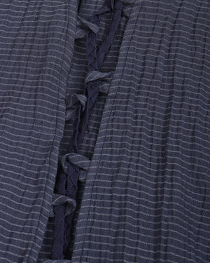 Close-up of a blue textured fabric with ruffled details