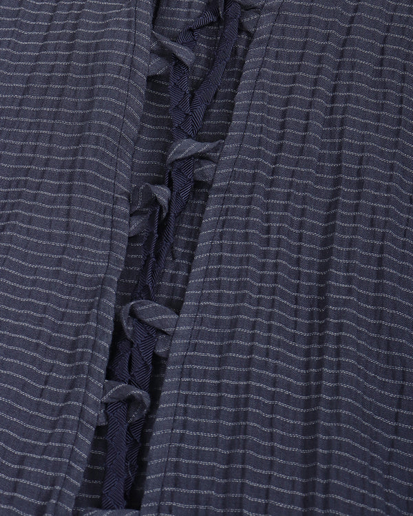 Close-up of a blue textured fabric with ruffled details