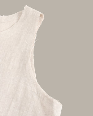 Close-up of a beige sleeveless top on a gray background