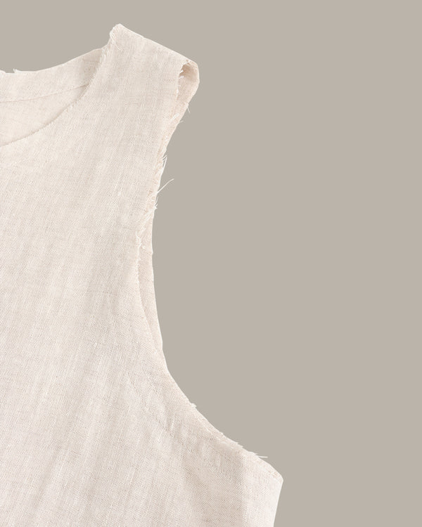 Close-up of a beige sleeveless top on a gray background