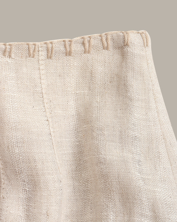 Close-up of beige fabric with a textured surface on a neutral background
