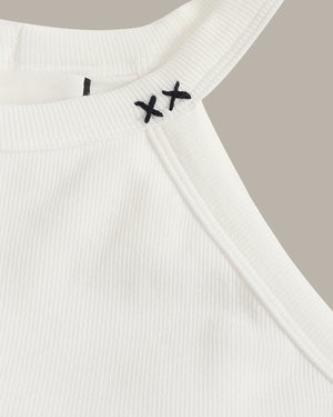 White ribbed tank top with black embroidery on a neutral background
