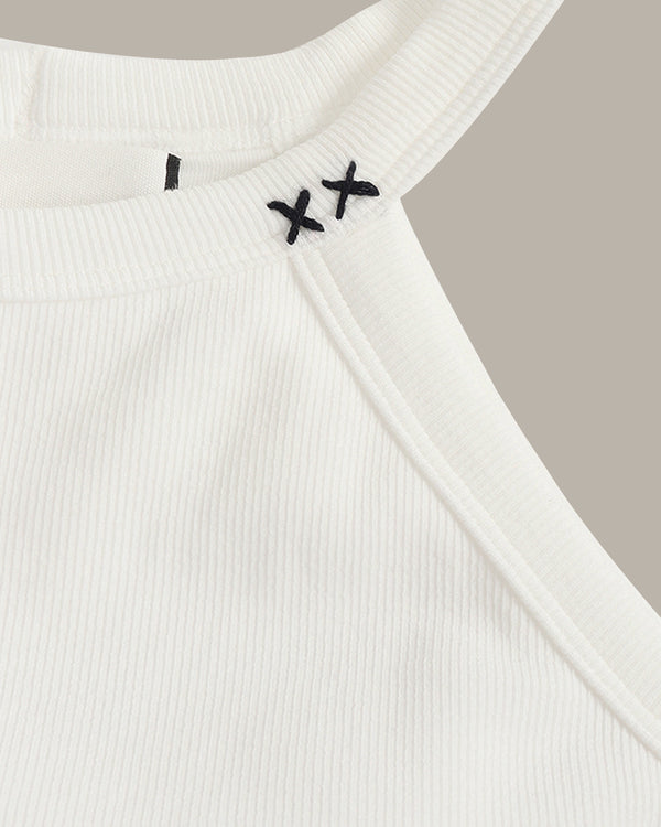 White ribbed tank top with black embroidery on a neutral background