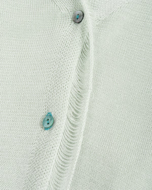 Close-up of a light gray shirt with button details