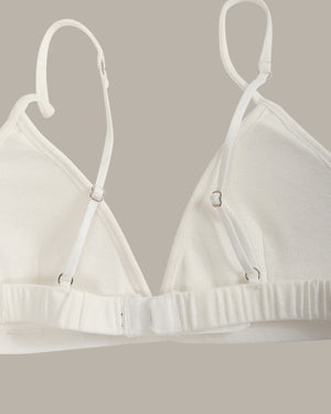 White bra on a hanger against a neutral background