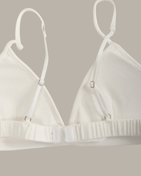 White bra on a hanger against a neutral background