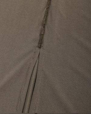Close-up of olive green fabric with a zipper