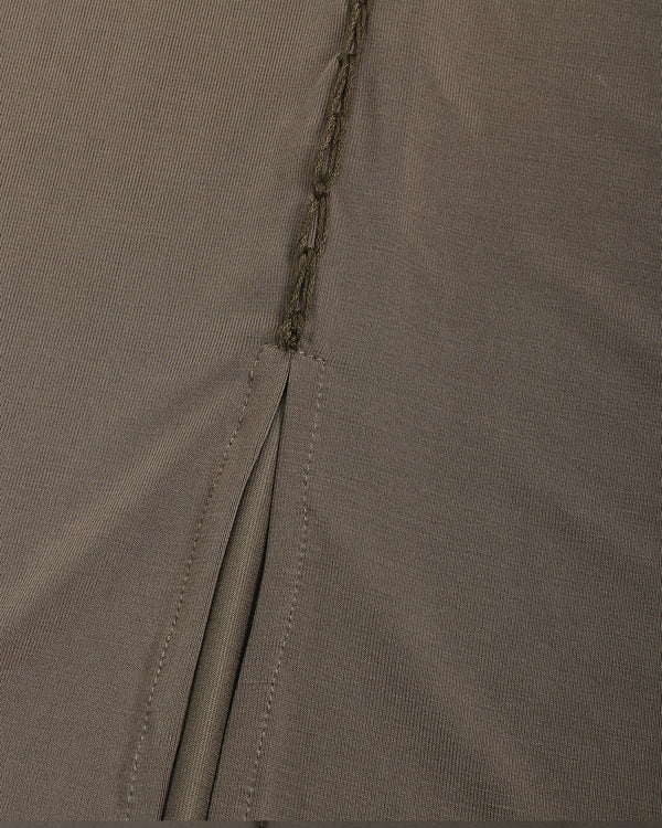 Close-up of olive green fabric with a zipper