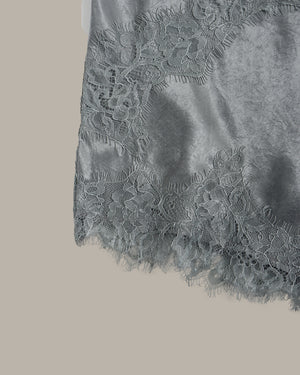 Close-up of a gray lace fabric on a beige background