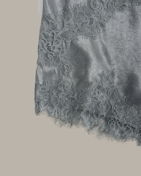 Close-up of a gray lace fabric on a beige background