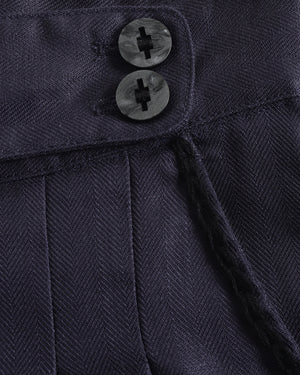 Close-up of a navy blue textured fabric with two buttons.