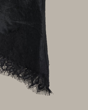 Black lace trim on a neutral background