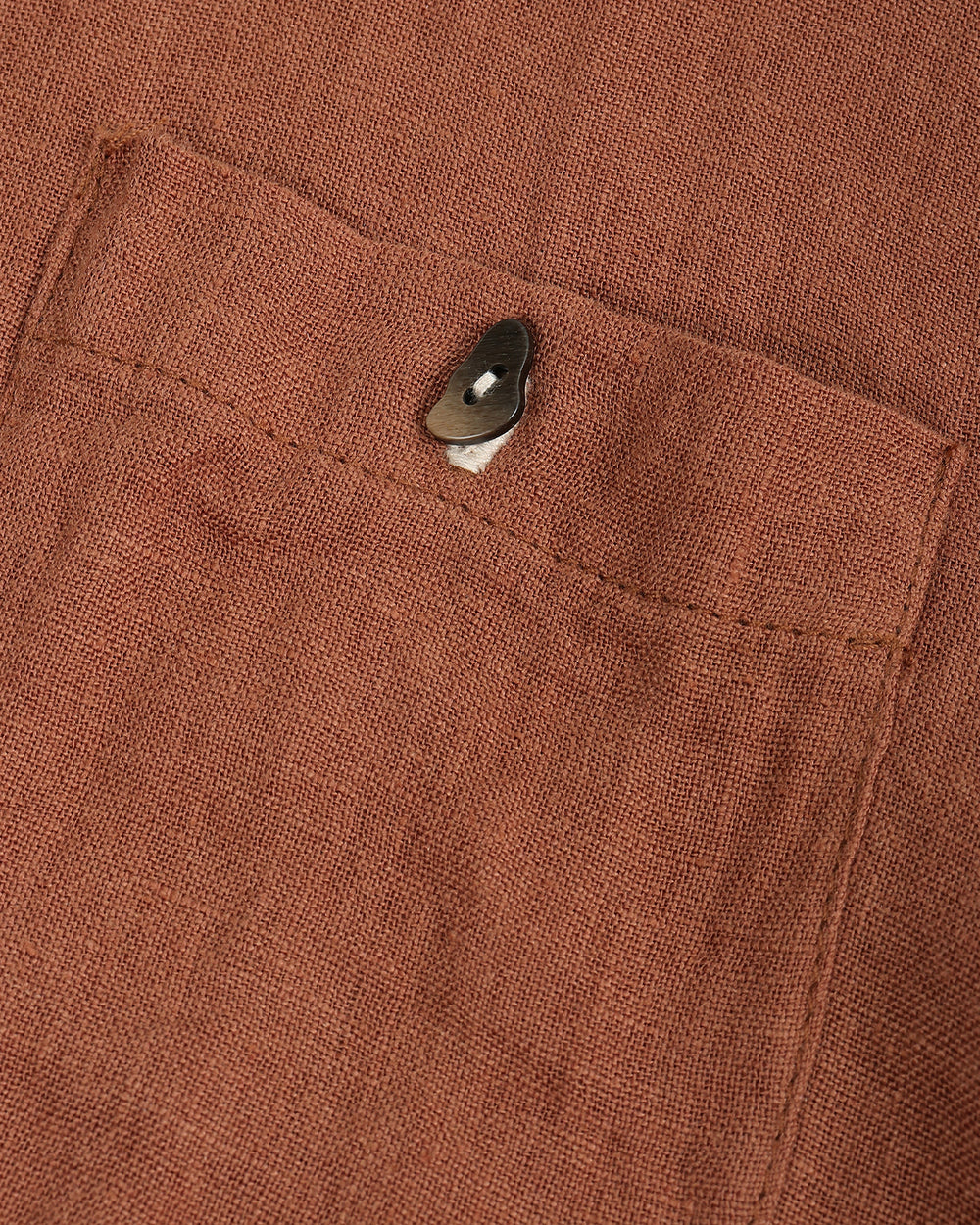 Brown button-up shirt on a beige background