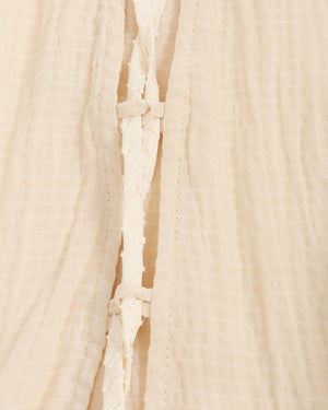 Close-up of beige top with a textured pattern