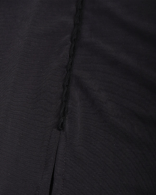 Close-up of black fabric with a visible seam