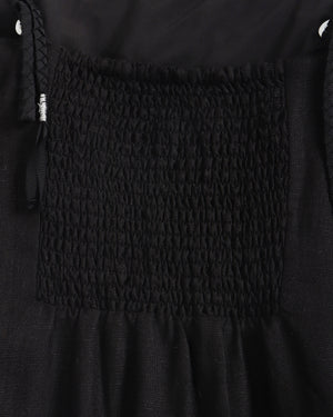 Close-up of a black textured fabric with a patterned square design.