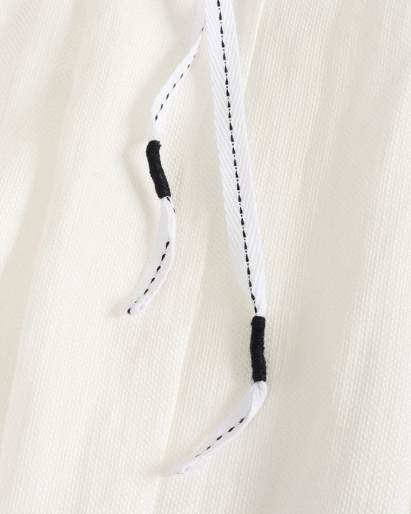 Close-up of a white rope with black ends on a beige background
