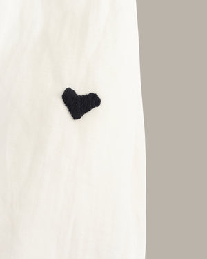 Black heart-shaped object on a white background
