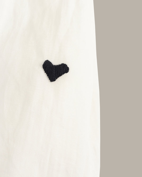 Black heart-shaped object on a white background