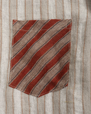 Striped shirt with a pocket featuring diagonal red and brown stripes on a light background