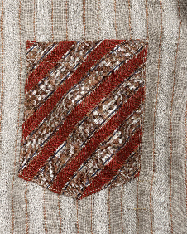Striped shirt with a pocket featuring diagonal red and brown stripes on a light background