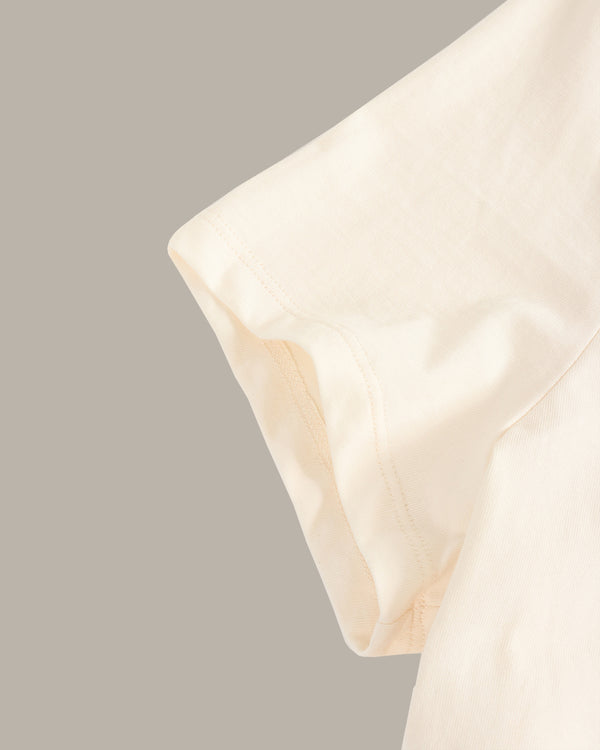 Close-up of a beige pillow on a neutral background