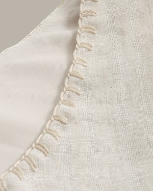 Close-up of a beige fabric with decorative stitching