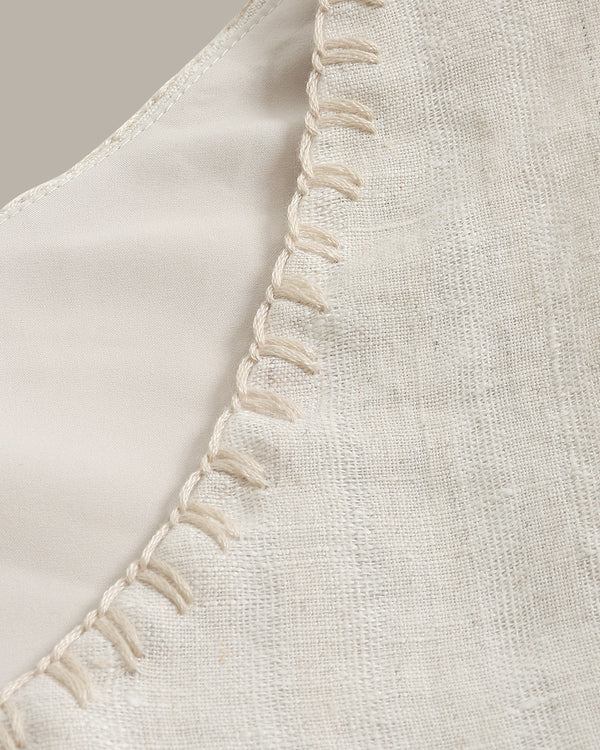 Close-up of a beige fabric with decorative stitching