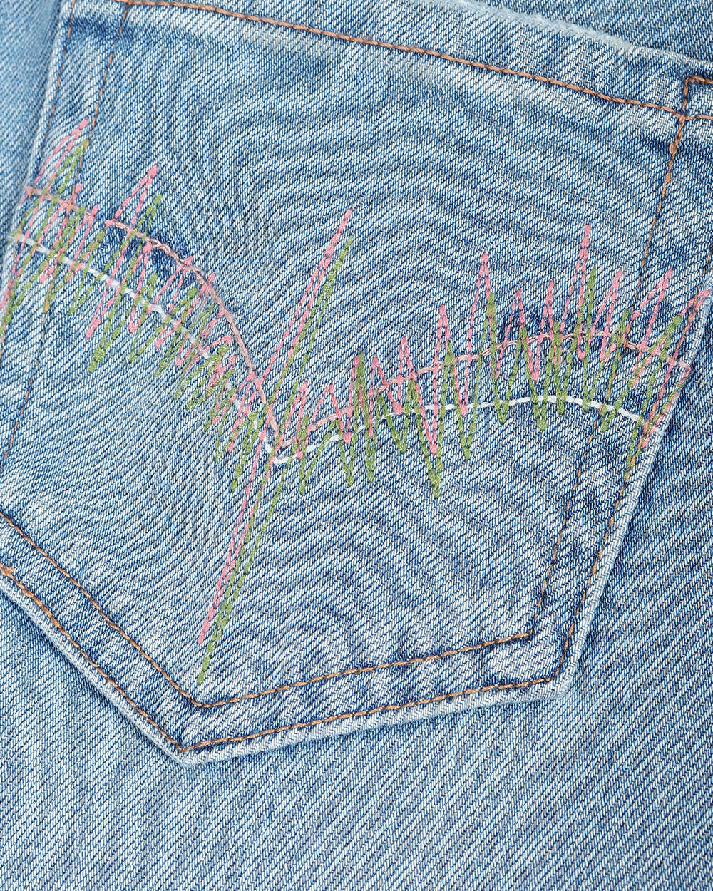 Light blue denim jeans with a straight-to-flare leg, shown flat against a solid taupe background.