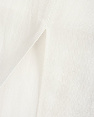 Close-up of white fabric with a subtle pattern