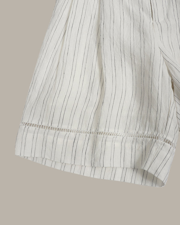 Close-up of a white shirt with black vertical stripes on a beige background